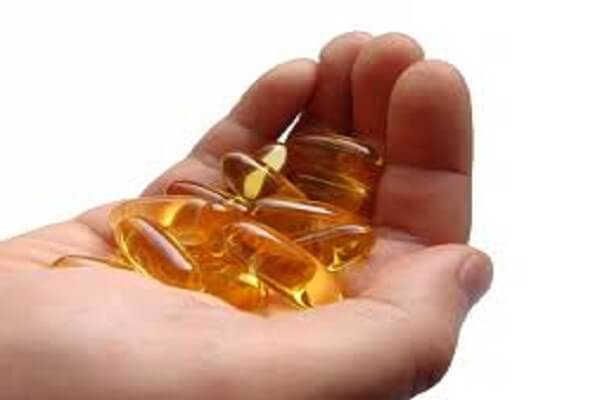 Касторовое масло в капсулах на ладони Касторовое масло в капсулах